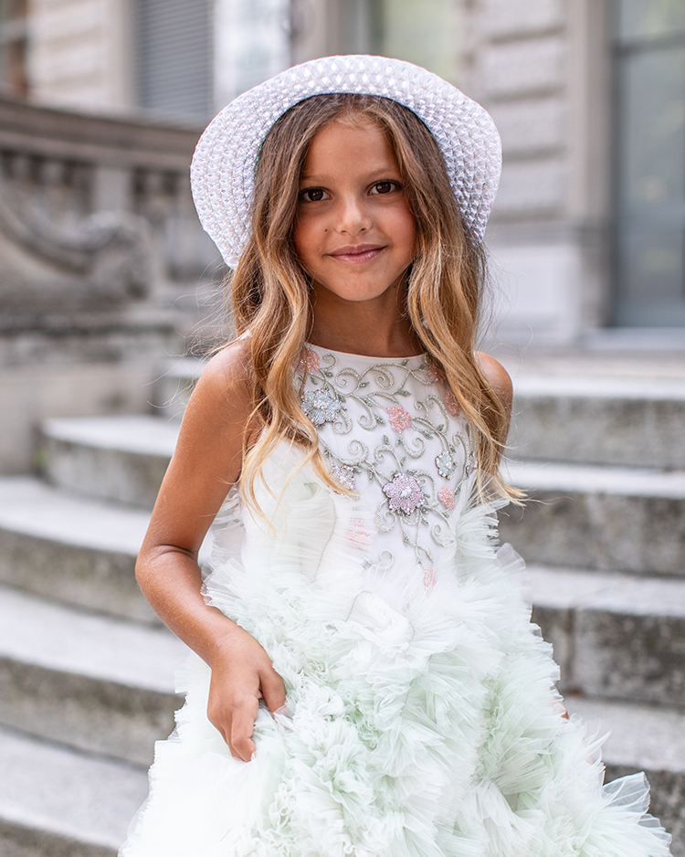Girl in a mint embellished tulle gown with pearl hat